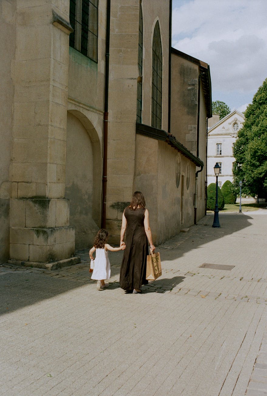 mother and daughter walking together along church